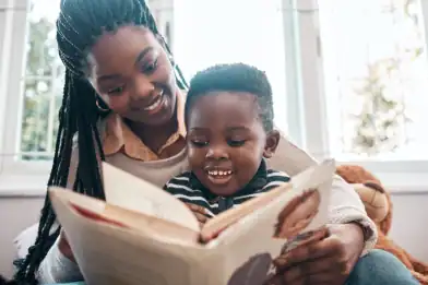 A heartwarming moment of a mother and child bonding through reading.