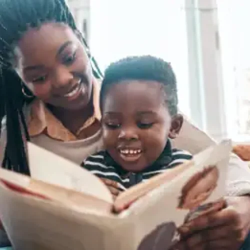A heartwarming moment of a mother and child bonding through reading.